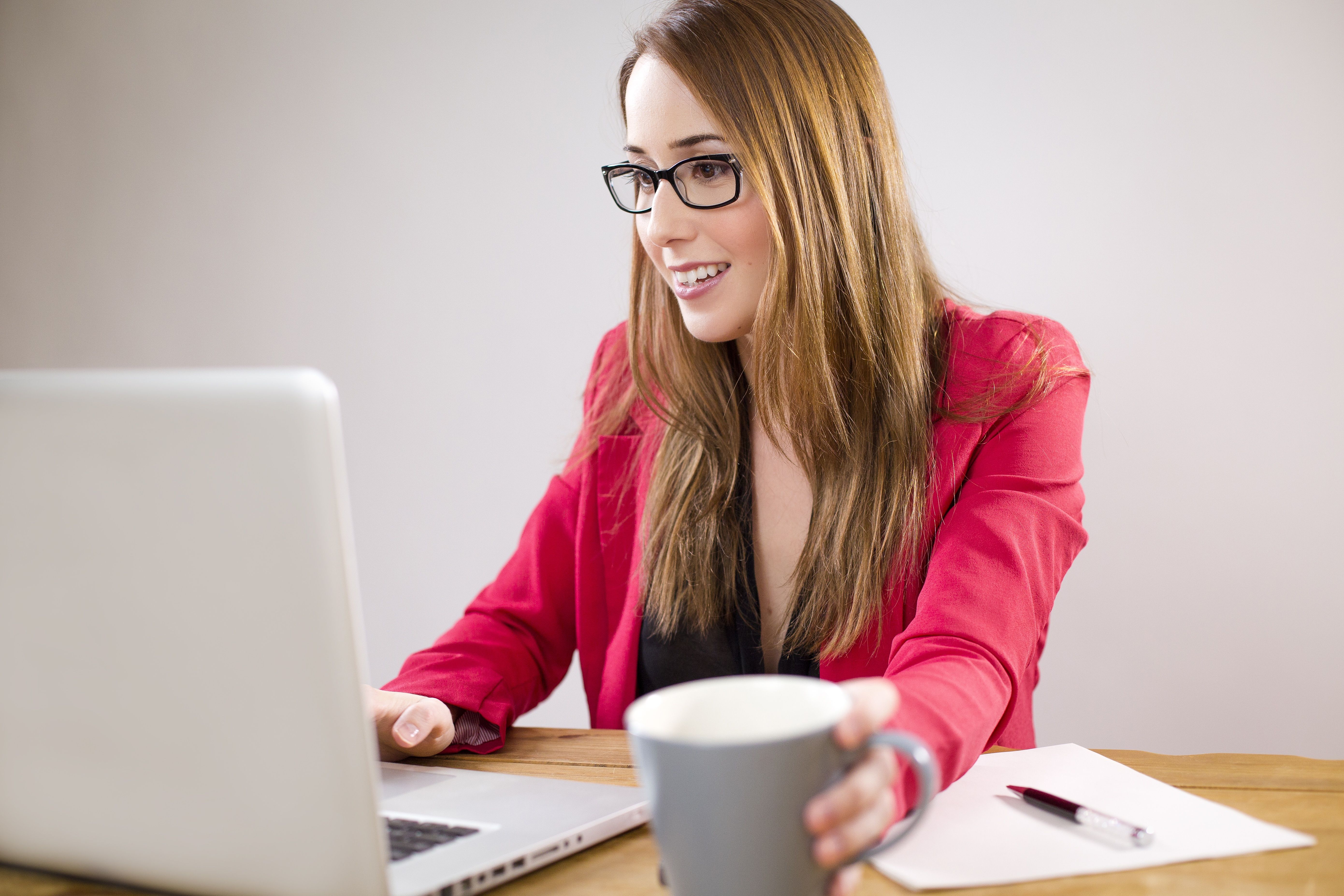 Business Woman - Using AlkaHub on Laptop